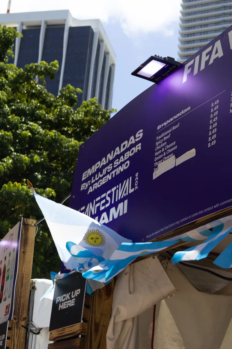 Official FIFA World Cup 26 menu sign featuring Luji's Sabor Argentino empanadas